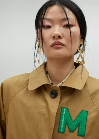 Beige trench coat with patch details