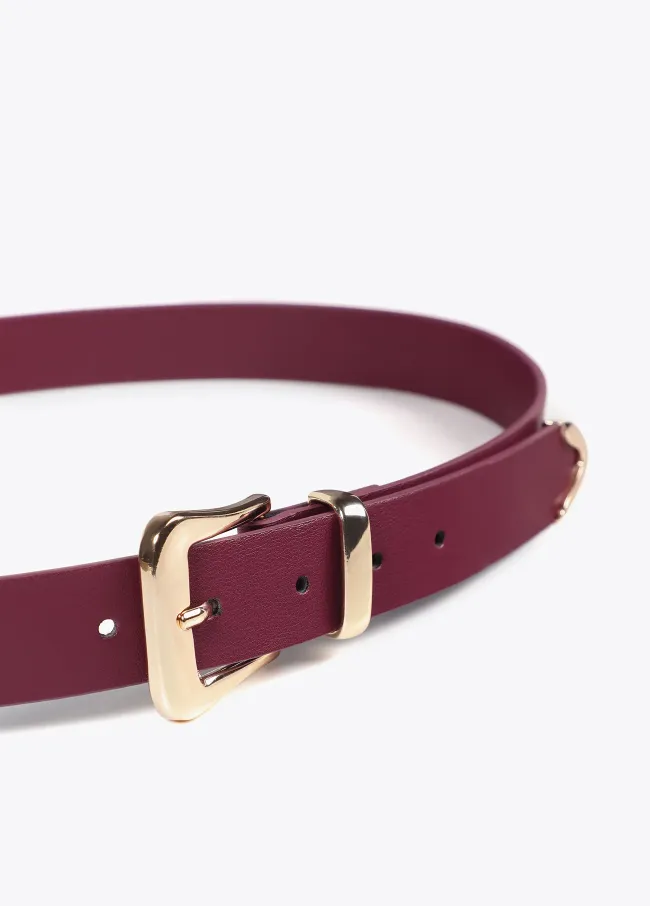 Belt with knot and cutwork logo