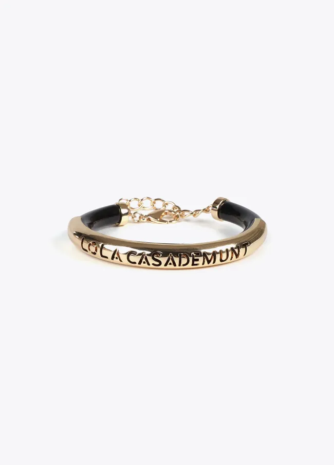 Acrylic tube bracelet with metal cutwork logo