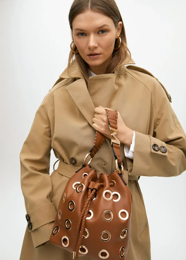 Pouch bag with circular metallic eyelets