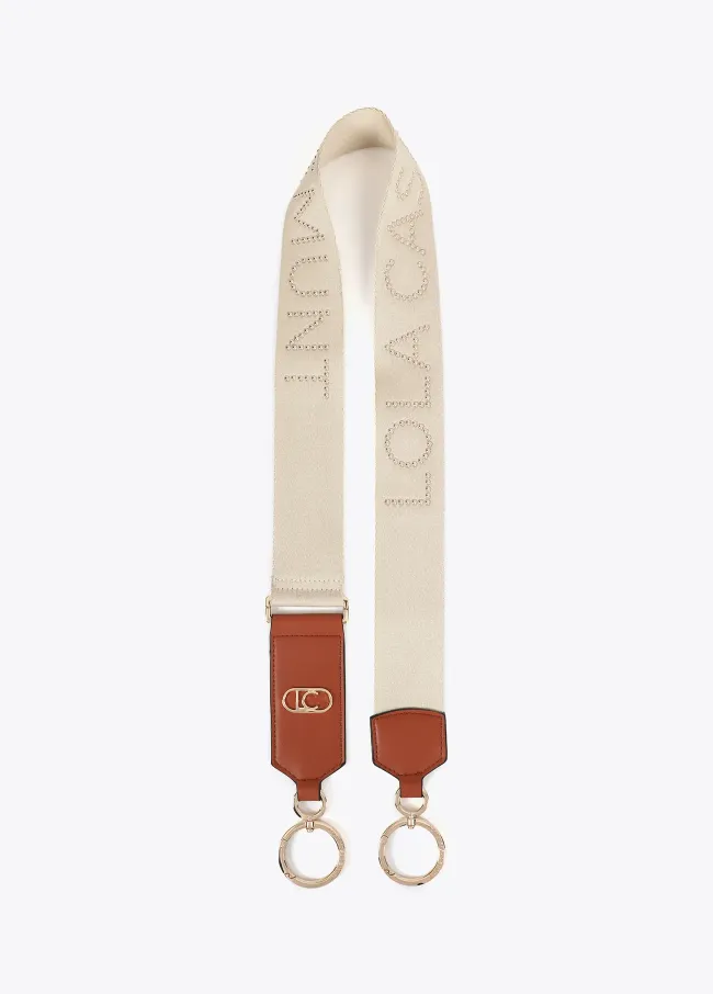 Bag strap with metallic studs and logo