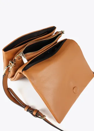 Faux leather crossbody bag with three compartments and flap.