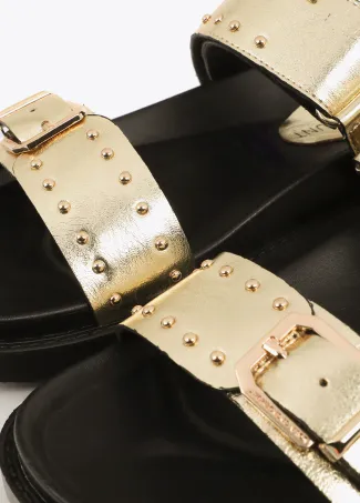 Flat sandals with straps and metal details