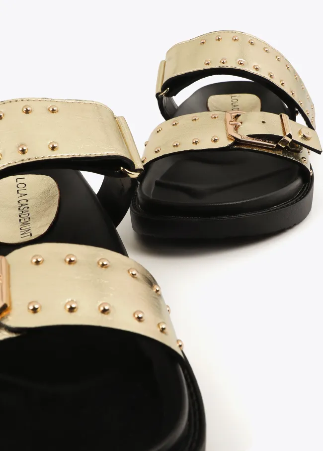 Flat sandals with straps and metal details
