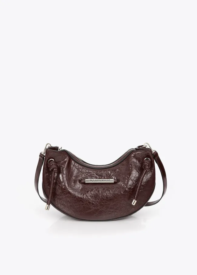 Half-moon shoulder bag with metallic tube detail with...